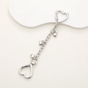 Silver metal chain keychain accessory featuring double heart clasps and three heart charms