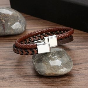 Detail shot of multi-layer braided leather men's bracelet with a silver magnetic clasp