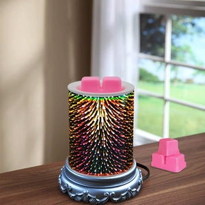Pink wax melts on wood table beside 3D fireworks effect electric wax warmer lamp