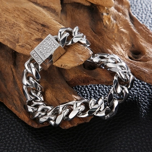 Minimalist silver Cuban link bracelet with iced-out CNC diamond clasp on wood base