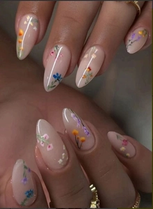 Detail of almond press-on nails featuring hand-painted floral art in soft pastel colors