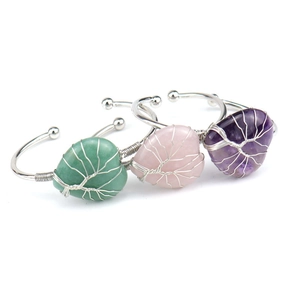 Detailed view of three handmade wire wrapped heart shaped natural crystal open bangles