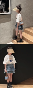 Girl's denim plaid drawstring bucket bag styled with casual outfit on wooden steps
