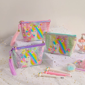 Detailed view of rainbow unicorn cosmetic bags with sequins and fluffy tail charms