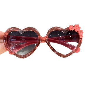 Sparkly heart-shaped kids sunglasses with glitter red frame and pink floral accents