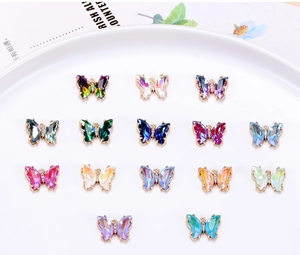 Detailed view of colorful crystal butterfly charms with gold base for DIY jewelry making