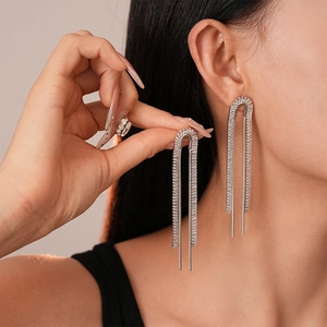 Elegant silver tassel earrings with U-shaped design and sparkling zirconia stones