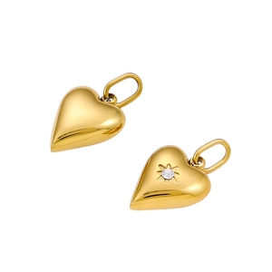 Detail of gold heart charms featuring a sparkling zircon in an octagonal star setting
