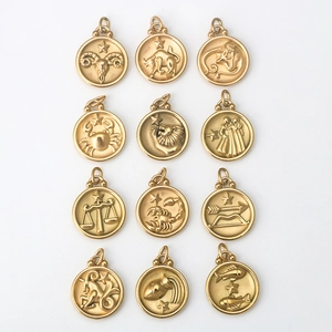 Macro view of 12 golden stainless steel zodiac pendants in a neat matrix arrangement