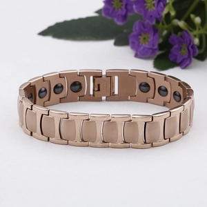 Macro detail of rose gold magnetic therapy bracelet with embedded hematite stones