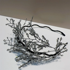 Elegant crystal beaded headband with black wire mesh branch design on white surface