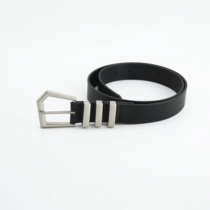 Close-up of black leather belt with silver pentagon buckle and triple metal loops