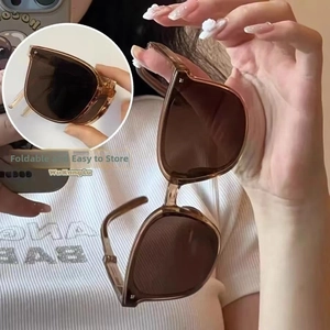 Detail of tortoiseshell folding sunglasses with compact structure and dark lenses
