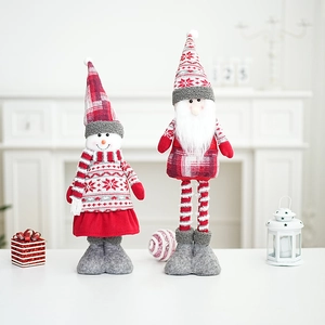 Festive Santa and snowman plush dolls with red knitting and fur details on white fireplace