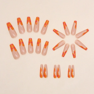 Long coffin fake nails with orange graffiti heart patterns and glossy nude base