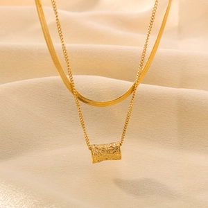 Double layered 18k gold plated necklace with flat snake chain and textured cylinder pendant