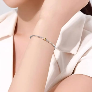Close-up of S999 sterling silver bead bracelet with a gold accent on a woman's wrist