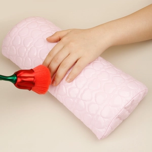 Detailed view of pink heart-quilted nail hand rest with a rose-shaped manicure brush