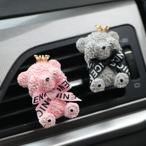 Detail of pink and grey teddy bear car air vent clips with crowns and ribbon ties