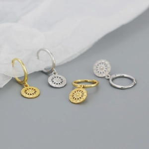 Detailed view of S925 silver celestial starburst hoop earrings in gold and silver finish