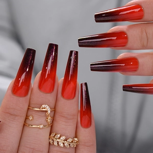 Detailed view of glossy long coffin press-on nails with red to black gradient finish