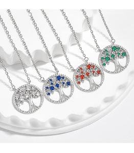 Close-up of bohemian tree of life pendants with colorful zircon stones in silver finish