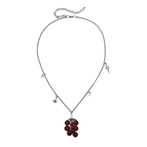 Vintage silver necklace with red resin grape pendant and star charms on white background