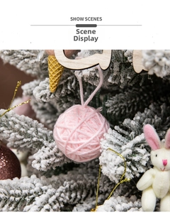 Pink yarn ball ornament with snow-covered branches for Christmas tree decor scenes
