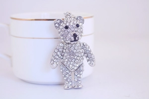 Detail of silver jointed teddy bear keychain with sparkling crystals and black stone eyes