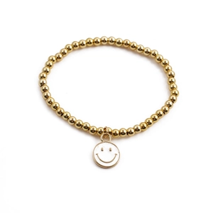 Golden beaded bracelet with a white smiley face pendant on a clean white background
