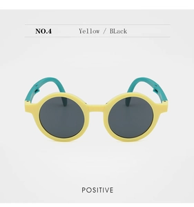 Front view of yellow and teal kids round sunglasses with matte texture and dark lenses