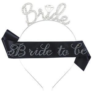 Close-up of a silver rhinestone Bride headband and a black satin Bride to be sash set