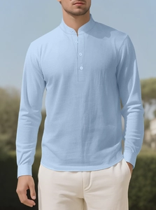 Detail of light blue linen shirt featuring a grandad collar and three-button placket