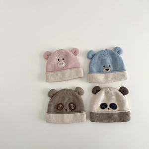 Close-up of baby winter knit hats with 3D ears and cute embroidered animal faces