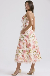 Close-up of pink floral dress with beige lace hem and waist drawstring detail
