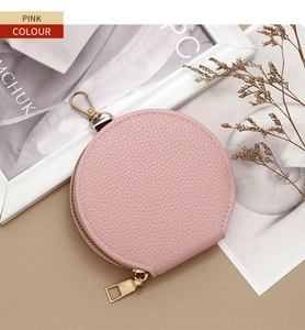 Pink lychee grain round coin purse with gold zipper and hook in aesthetic scene