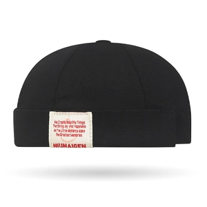 Retro black cotton docker cap with street style woven label and minimalist brimless design