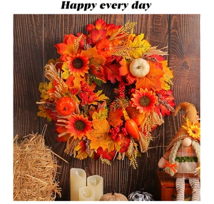 Close-up of autumn harvest wreath with maple leaves, sunflowers, and mini pumpkins