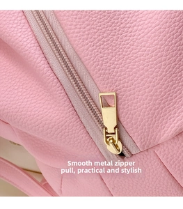 Detail of pink lychee leather surface and high-quality gold metal zipper head of the backpack