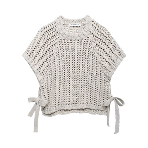 Detail of off-white chunky knit short sleeve top with side bow tie and openwork texture