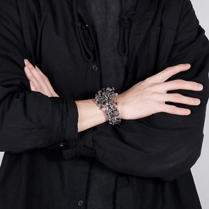Gothic wide skull bangle in silver finish shown on model with punk style engraving