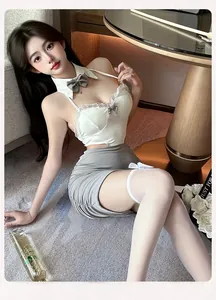 Detail of gray ribbed mini skirt and white lace camisole set with bow stockings