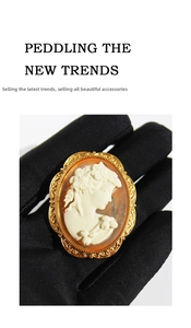 Detail of vintage Victorian style relief cameo brooch with golden filigree frame