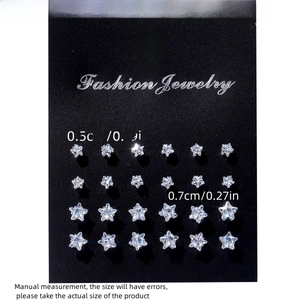 Detail view of 12 pairs of star-shaped zircon earrings in 0.5cm and 0.7cm sizes