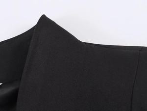 Detailed close-up of the black suit jacket collar showing high-quality fabric and stitching