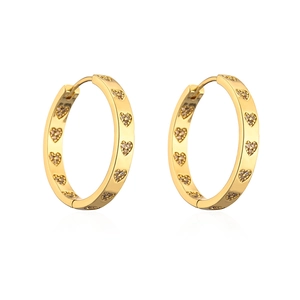 Detailed view of gold hoop earrings with heart-shaped engravings and cubic zirconia stones