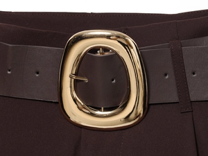 Detailed close-up of dark brown trousers featuring a leather belt with a golden oval buckle