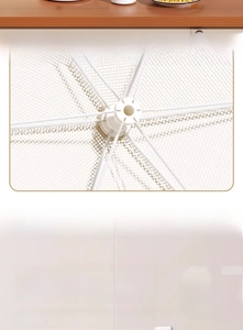 Detail view of the foldable white mesh food cover showing the flexible frame and wall hook