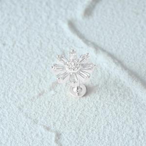 Macro shot of 925 sterling silver flower stud earring with shimmering crystal tassels
