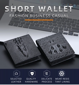 Close-up of black crocodile pattern leather wallet on laptop in business setting